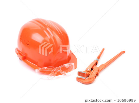 Red safety helmet and adjustable pipe wrench. Red safety helmet and adjustable pipe wrench. 10696999