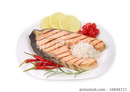 Grilled salmon steak with vegetables on plate. 10698721