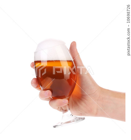 Hand holds glass of beer. 10698726