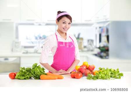 Happy smiling woman in kitchen Happy smiling woman in kitchen 10698808
