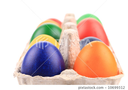 Cardboard egg box with Easter colored eggs Cardboard egg box with Easter colored eggs 10699312
