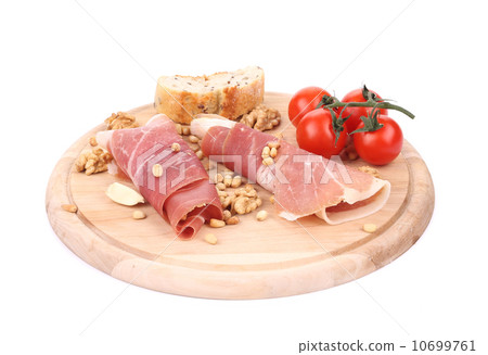 Composition of prosciutto on wooden platter. 10699761