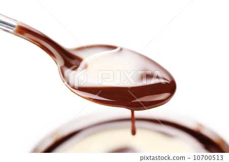 Spoon with liquid chocolate. Spoon with liquid chocolate. 10700513