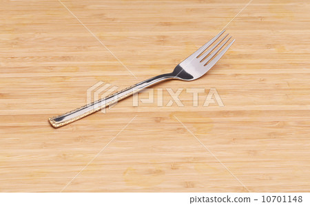 Fork on wooden texture. Close up. 10701148