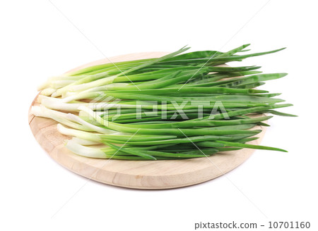 Bunch of green onion on wooden platter. Bunch of green onion on wooden platter. 10701160