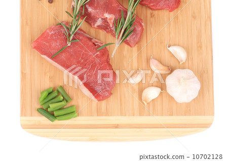 Raw steaks on cutting board. Raw steaks on cutting board. 10702128