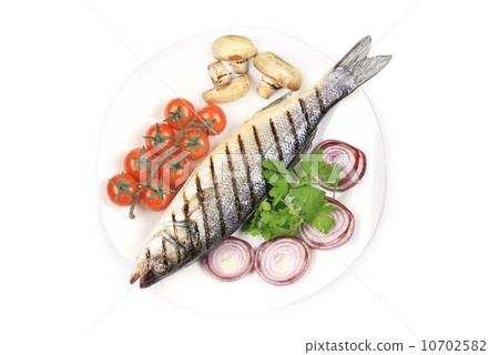 Grilled seabass on plate with mushrooms. 10702582