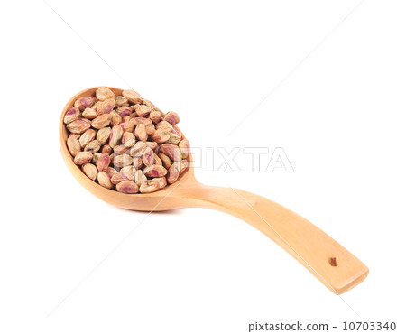 Wooden spoon with peeled pistachios. Wooden spoon with peeled pistachios. 10703340