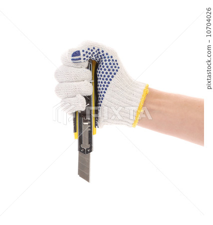 Hand holds yellow stationery knife. Hand holds yellow stationery knife. 10704026