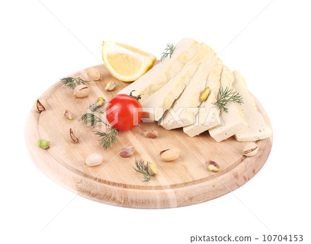 Slices of tofu on wooden platter. Slices of tofu on wooden platter. 10704153