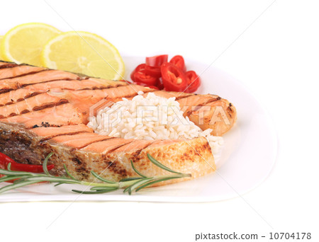 Grilled salmon steak with vegetables on plate. 10704178