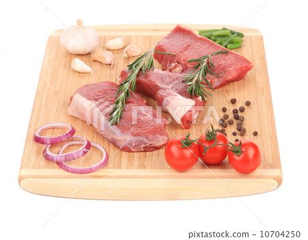 Raw steaks on cutting board. Raw steaks on cutting board. 10704250