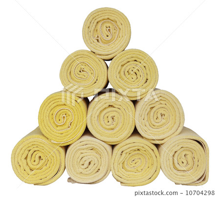 Rolled up spa towels on white 10704298