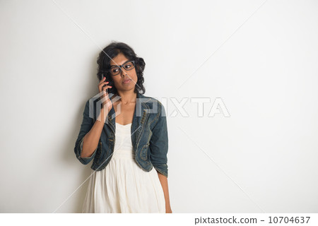 casual indian female with grey background casual indian female with grey background 10704637