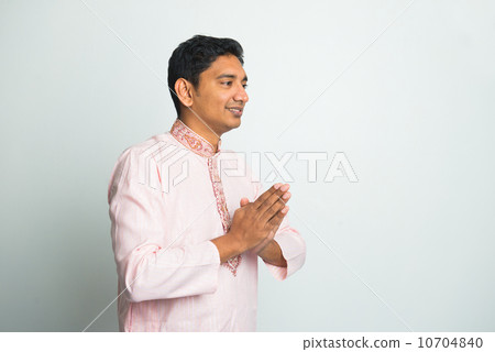 young indian male with Pranamasana greetings sign on traditional 10704840
