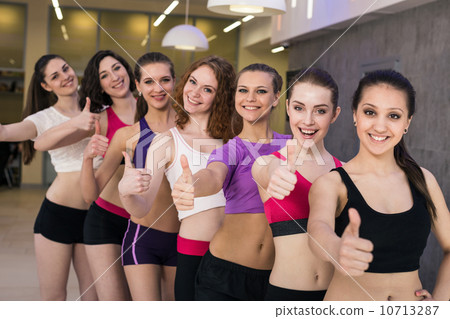 Group gesturing thumbs up 10713287