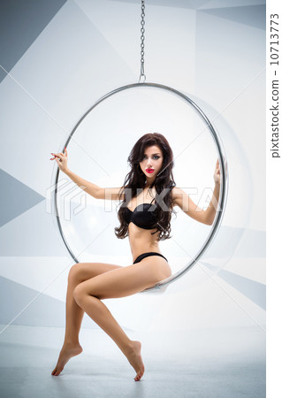 Sexy woman suspended from an aerial hoop Sexy woman suspended from an aerial hoop 10713773