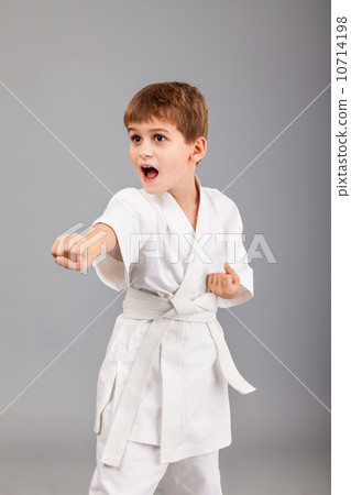 Karate boy in white kimono fighting Karate boy in white kimono fighting 10714198