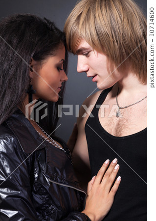 Portrait of happy young couple hugging 10714600