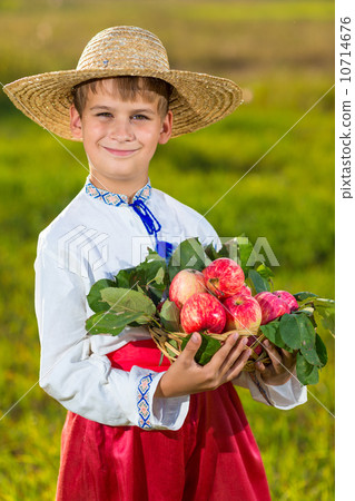 Happy farmer boy hold Organic Apples in Autumn Garden Happy farmer boy hold Organic Apples in Autumn Garden 10714676
