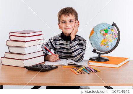 Cute schoolboy is writting 10714941