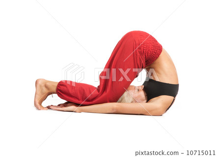 Practicing Yoga. Young woman isolated on white background 10715011