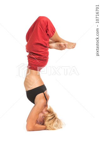 Practicing Yoga. Young woman isolated on white background Practicing Yoga. Young woman isolated on white background 10716701