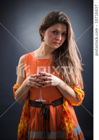 Woman with wine glass in hand 10716837