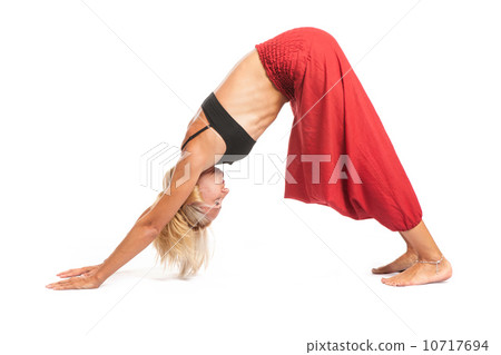 Practicing Yoga. Young woman isolated on white background Practicing Yoga. Young woman isolated on white background 10717694