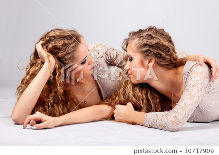 Two girls twins, isolated on the grey background Two girls twins, isolated on the grey background 10717909