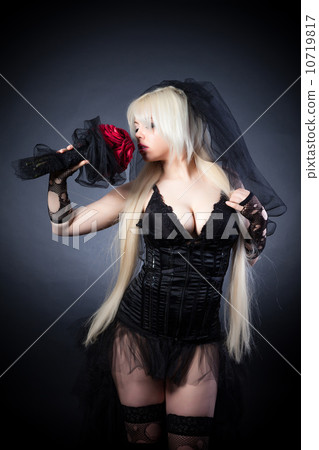 black widow in grief  with flowers  with a veil 10719817