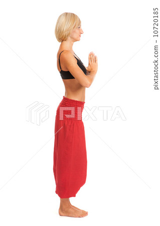 Practicing Yoga. Young woman isolated on white background Practicing Yoga. Young woman isolated on white background 10720185