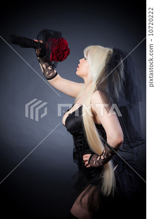 black widow in grief  with flowers  with a veil 10720222