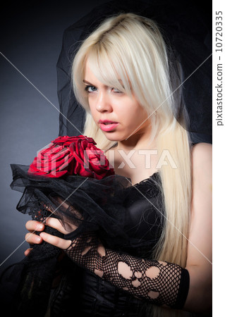 black widow in grief  with flowers  with a veil 10720335