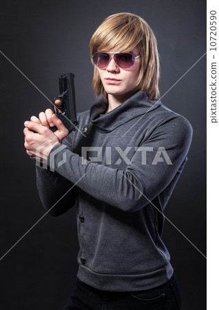 Aiming. Serious man with a gun 10720590