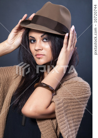 Beautiful woman with a hat on black 10720744