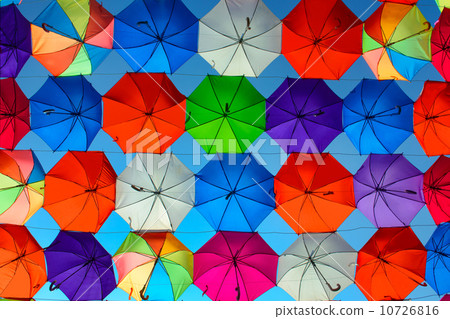 Background picture of a lot of colored umbrellas in front of blue sky Background picture of a lot of colored umbrellas in front of blue sky 10726816
