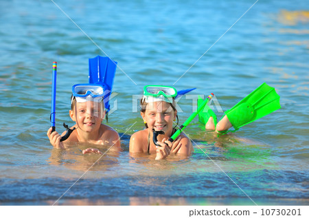 children on beach with snorkles 10730201