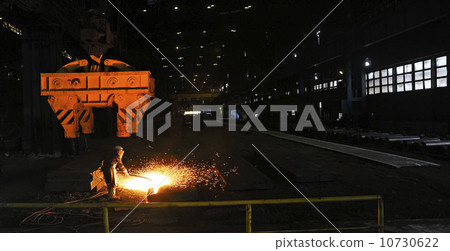 worker using torch cutter to cut through metal 10730622