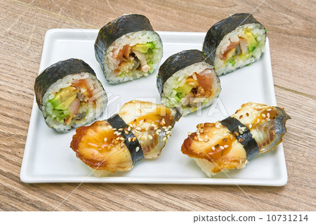 sushi and rolls on a plate on a wooden background sushi and rolls on a plate on a wooden background 10731214
