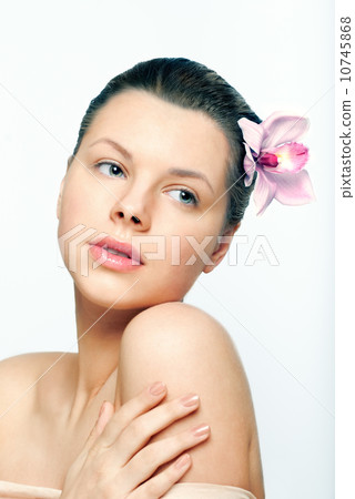 beautiful female face with healthy skin and flower in hair in sp 10745868