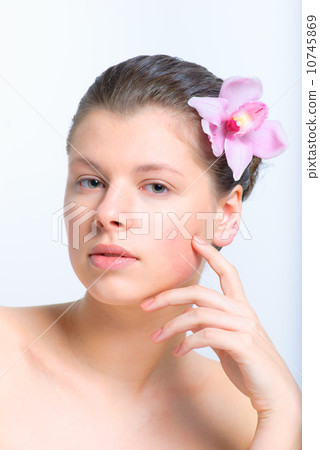beautiful female face with healthy skin and flower in hair in sp 10745869
