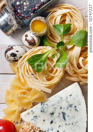 Overhead view of ingredients for an Italian pasta recipe on rust 10747227