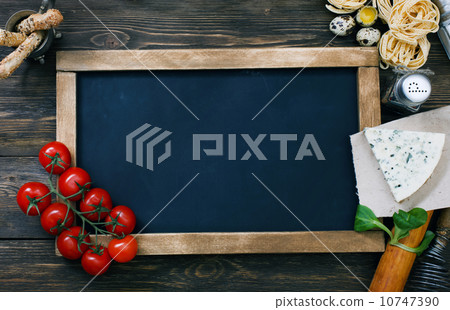 Italian food on vintage wood background with chalkboard 10747390