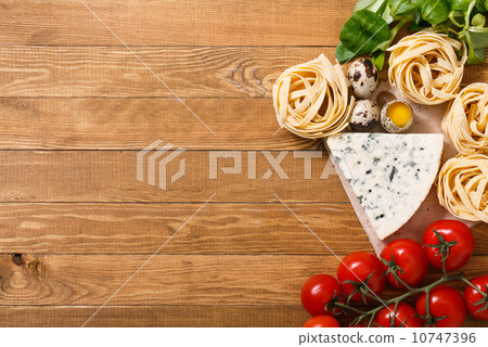 Ingredients for an Italian pasta recipe on rustic wood 10747396