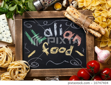 Italian food on vintage wood background with chalkboard 10747404