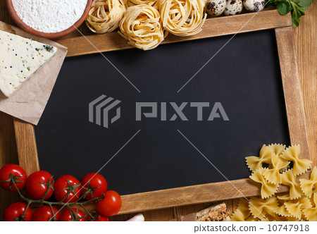 Italian food on vintage wood background with chalkboard 10747918