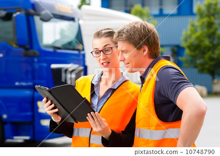 Forwarder in front of trucks on a depot 10748790