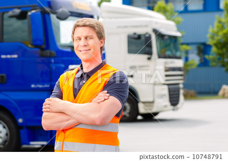 Forwarder in front of trucks on a depot 10748791