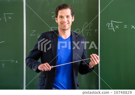 Teacher with pointer in front of a school class 10748829